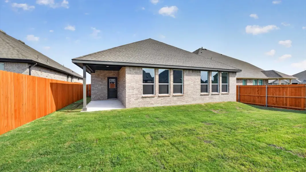 Exterior details and patio area of a home in Bluestem, Rhome (Image 3).