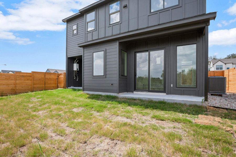 Rear view of property with a fenced backyard and board and batten siding Rear view of property with a fenced backyard and board and batten siding
