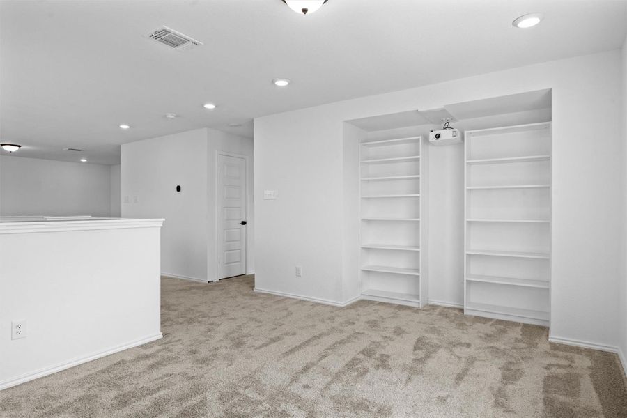 Empty room with recessed lighting and light carpet