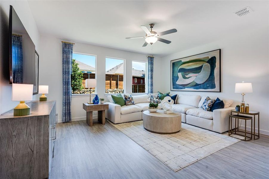 Living room featuring ceiling fan and light wood-type flooring