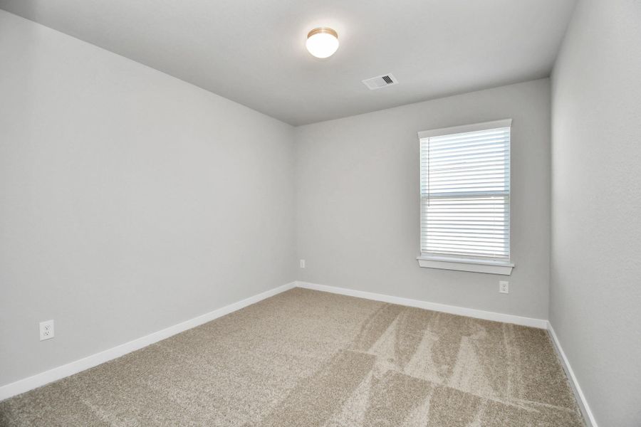 Discover another perspective of the spacious secondary bedrooms! Sample photo of completed home with similar floor plan. Actual colors and selections may vary.