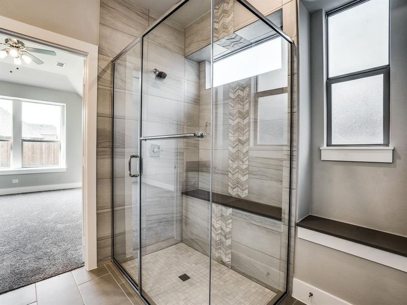 Bathroom with a shower stall, baseboards, tile patterned floors, and ceiling fan