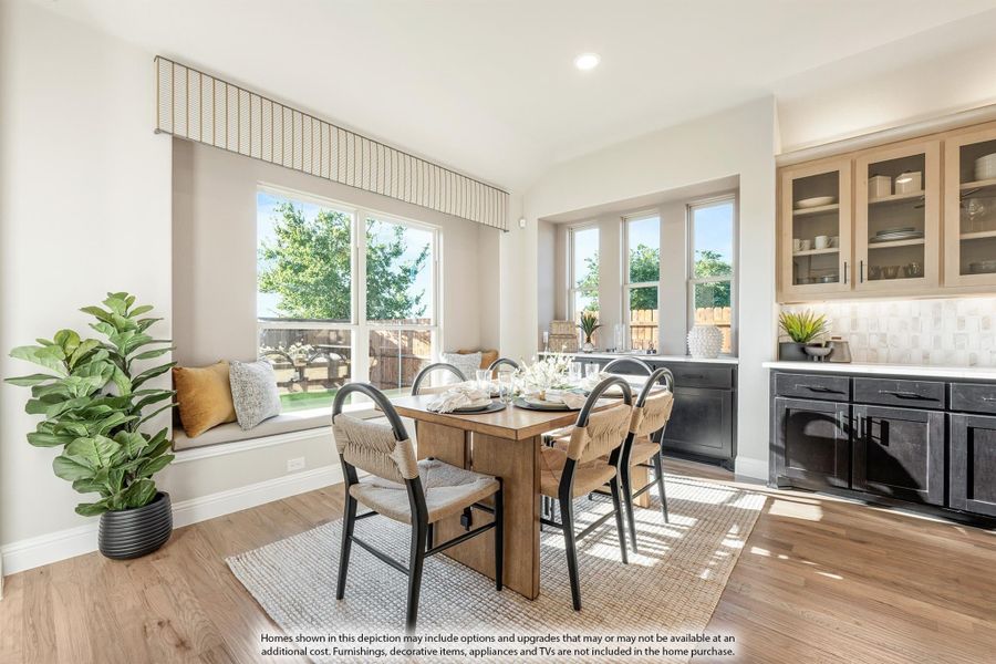 Dining area with wood table, four chairs, window seat, and hardwood floors next to a dark cabinet bar area Dining area with wood table, four chairs, window seat, and hardwood floors next to a dark cabinet bar area