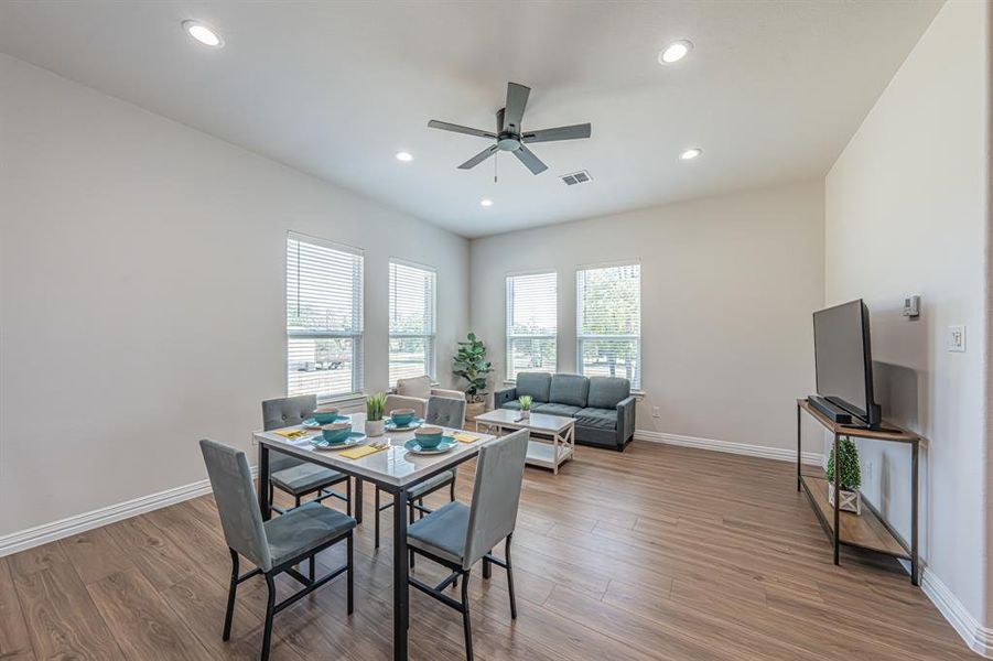 Dining room featuring light wood-style floors, recessed lighting, and a ceiling fan Dining room featuring light wood-style floors, recessed lighting, and a ceiling fan
