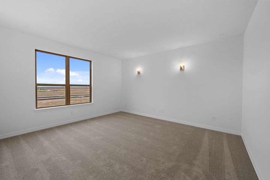 Another space meant for creating family memories, the media room has four gold sconce lights that sets the scene for movie night.