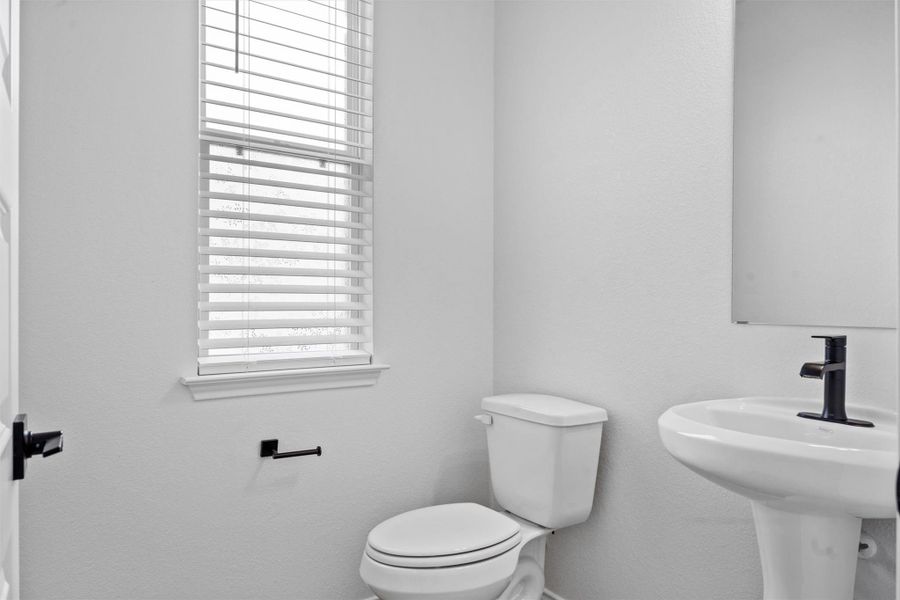 Bathroom featuring toilet and a textured wall