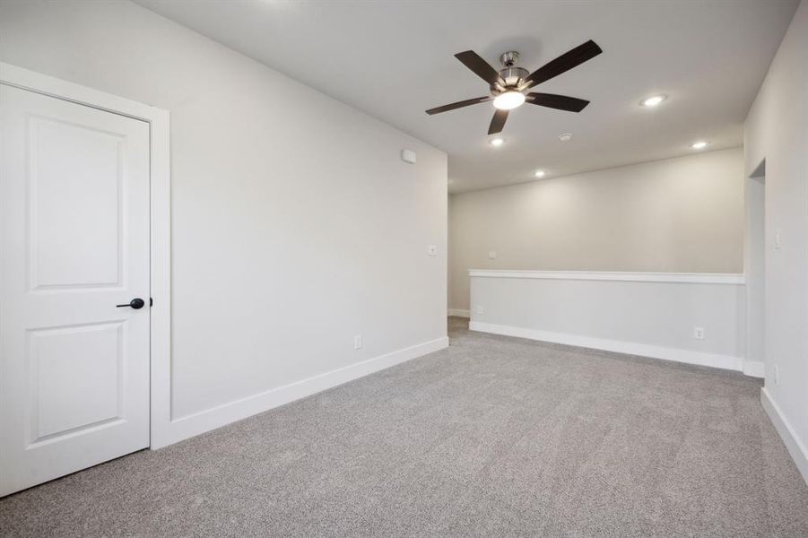 Spare room with ceiling fan and carpet