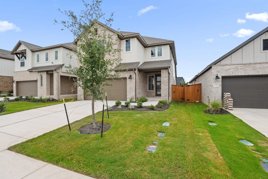Front exterior of a new home in Lariat, Liberty Hill, TX, highlighting curb appeal (Image 24).