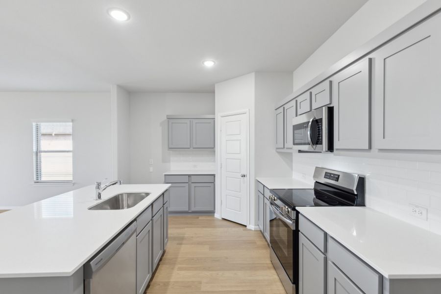 Kitchen in the Holden home plan by Trophy Signature Homes – REPRESENTATIVE PHOTO