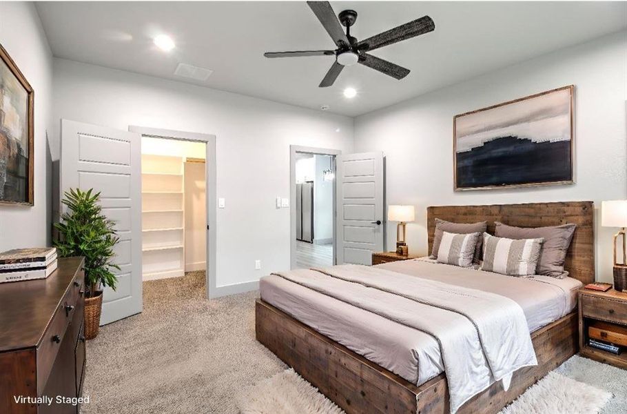 Bedroom with carpet flooring, a spacious closet, a ceiling fan, and recessed lighting Bedroom with carpet flooring, a spacious closet, a ceiling fan, and recessed lighting