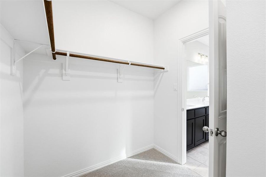 Spacious closet featuring light tile patterned floors
