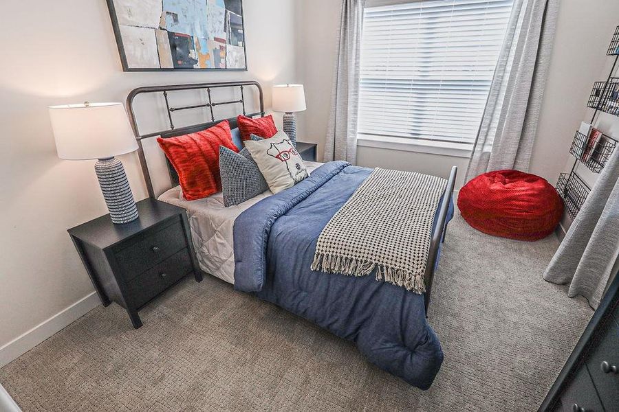 Carpeted bedroom with baseboards
