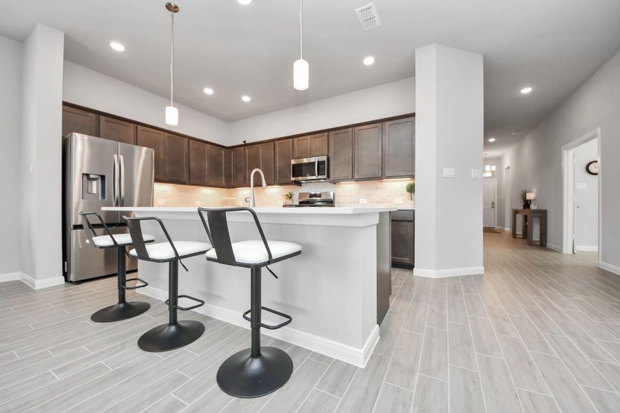 View from living room of kitchen.  Refrigerator is included with this home!