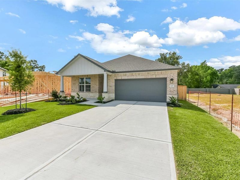 Front exterior of a new home in Sundance Cove, Crosby, TX, highlighting curb appeal (Image 2).
