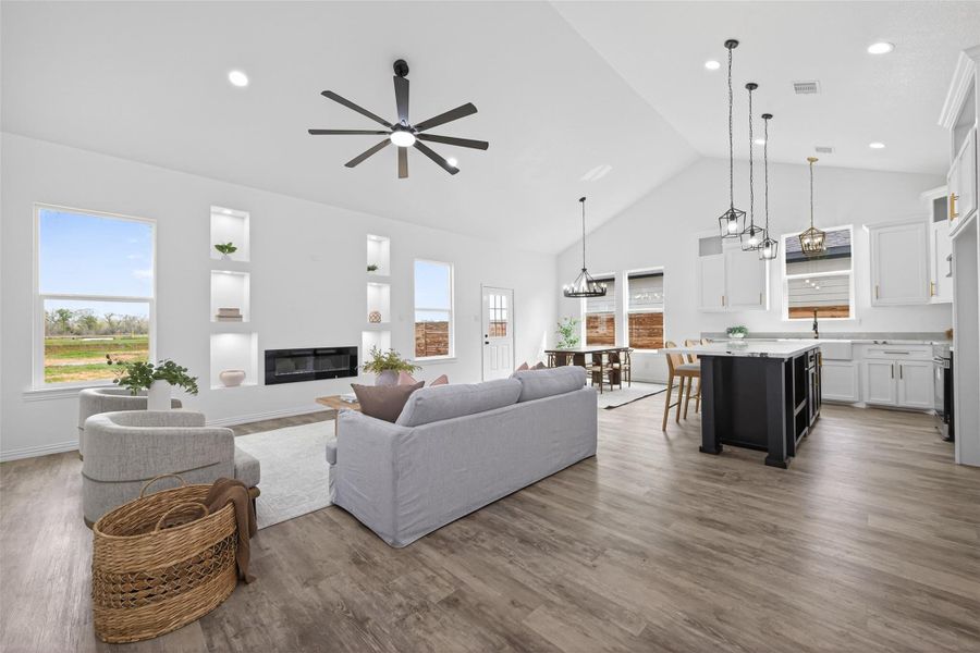 Seamless open-concept design connecting the living room, kitchen, and dining areas.