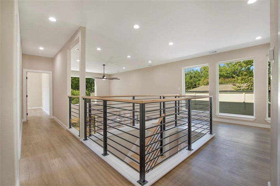 Hallway with hardwood / wood-style floors