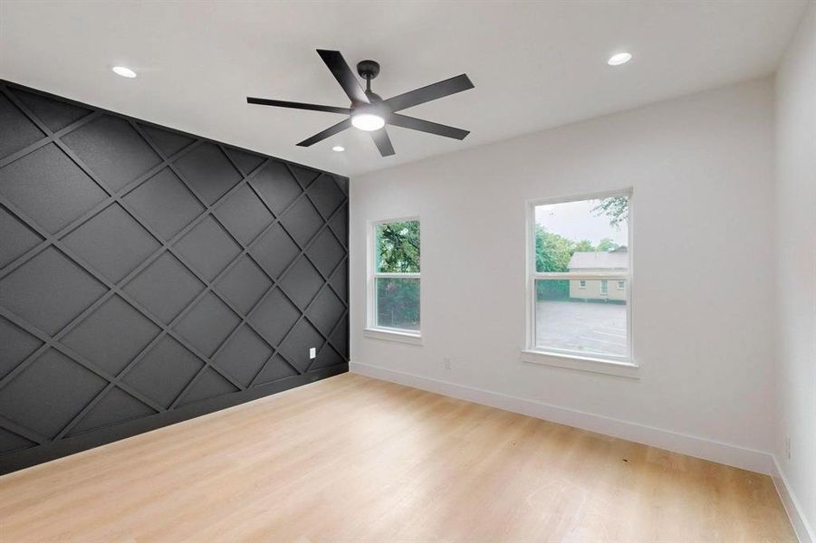 Spare room featuring an accent wall, wood finished floors, a ceiling fan, and recessed lighting Spare room featuring an accent wall, wood finished floors, a ceiling fan, and recessed lighting