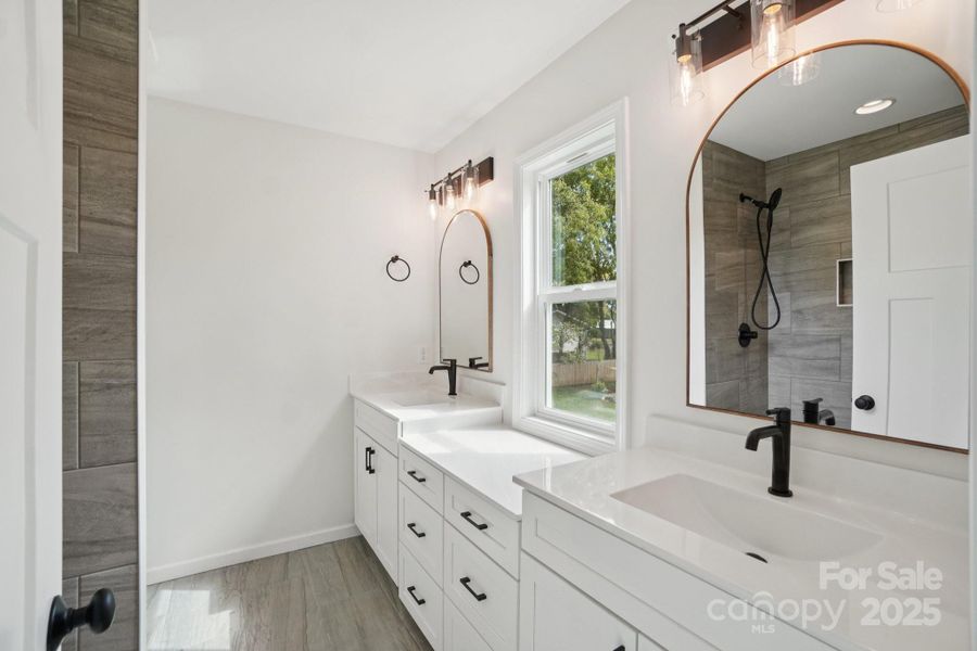 Primary Bathroom with large vanities and natural light