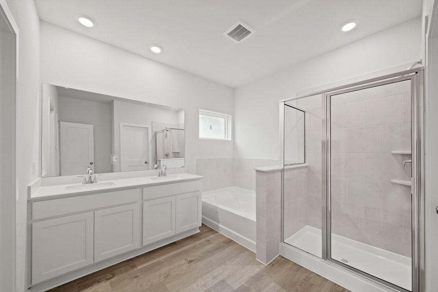 A bathroom with a glass shower. A bathroom with a glass shower.