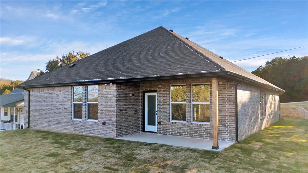 Back of house with a patio area and a yard