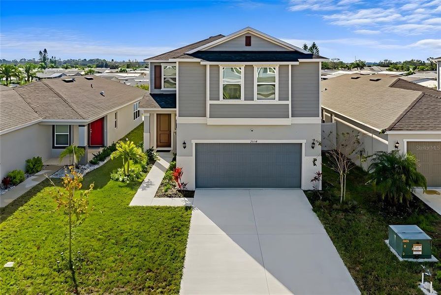 Front exterior of a new home in Heron Bay, Palmetto, FL, highlighting curb appeal (Image 1). Front exterior of a new home in Heron Bay, Palmetto, FL, highlighting curb appeal (Image 1).