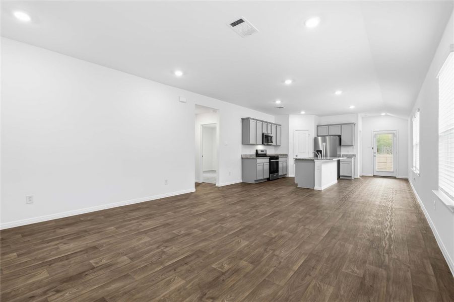 Toward the back, the main living space and kitchen connect easily making entertaining a breeze. Toward the back, the main living space and kitchen connect easily making entertaining a breeze.