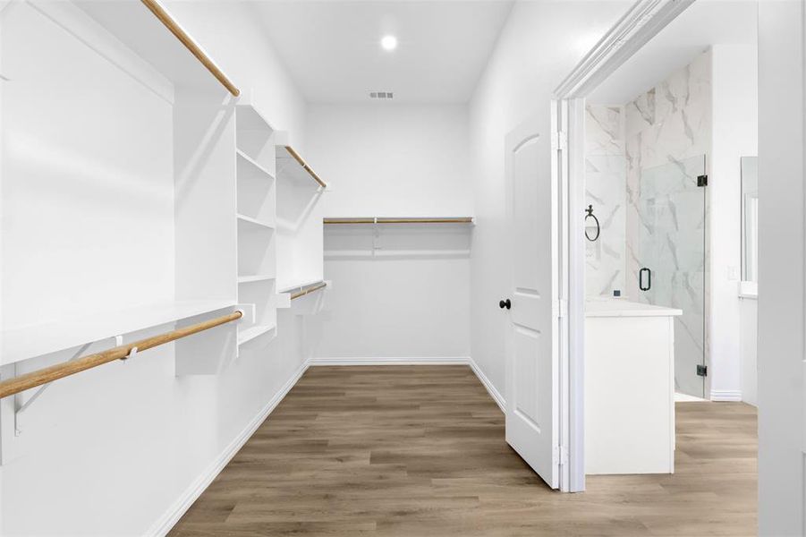 Walk in closet featuring hardwood / wood-style floors