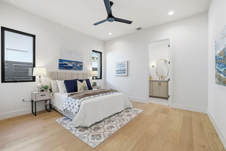 Bedroom featuring light wood-type flooring, a ceiling fan, recessed lighting, and connected bathroom