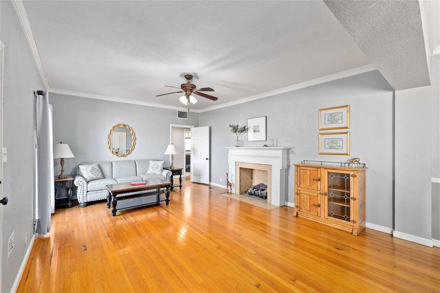 Living room with hardwood floors and gas log fireplace