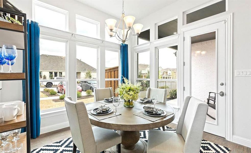 Dining area featuring a notable chandelier and hardwood / wood-style floors