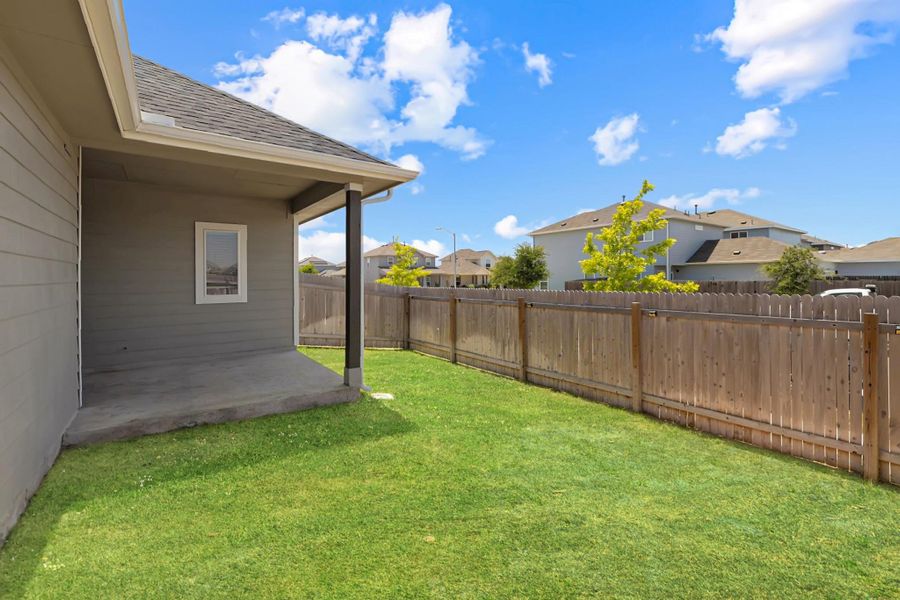 Fenced backyard featuring a patio and a residential view Fenced backyard featuring a patio and a residential view