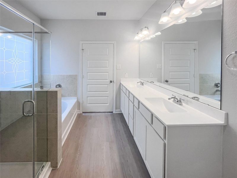The Waring III- Primary Bathroom with Dual Vanities, Separate Garden tub and Walk-in Shower. Sample image for illustration; upgrades, options, and colors may vary. The Waring III- Primary Bathroom with Dual Vanities, Separate Garden tub and Walk-in Shower. Sample image for illustration; upgrades, options, and colors may vary.