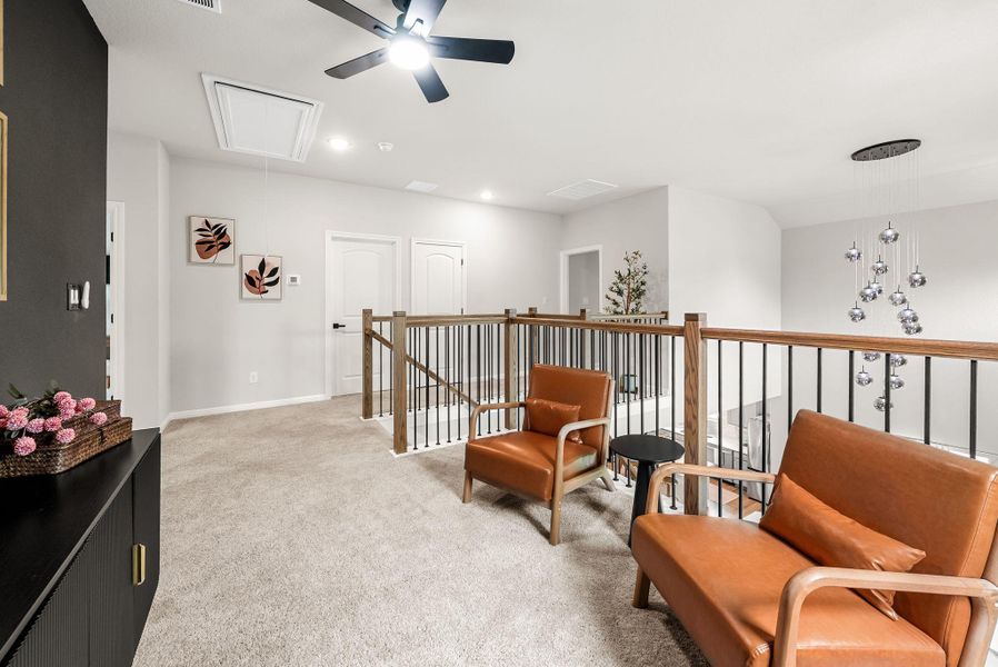 Living area featuring light colored carpet and recessed lighting