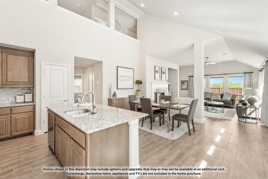 Open-concept kitchen with granite island flowing into dining and living areas, vaulted ceilings and wood-look floors throughout Open-concept kitchen with granite island flowing into dining and living areas, vaulted ceilings and wood-look floors throughout
