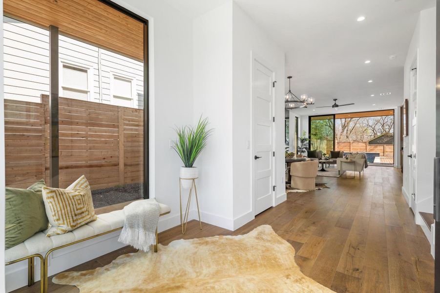 Hall featuring recessed lighting, expansive windows, baseboards, and hardwood / wood-style flooring