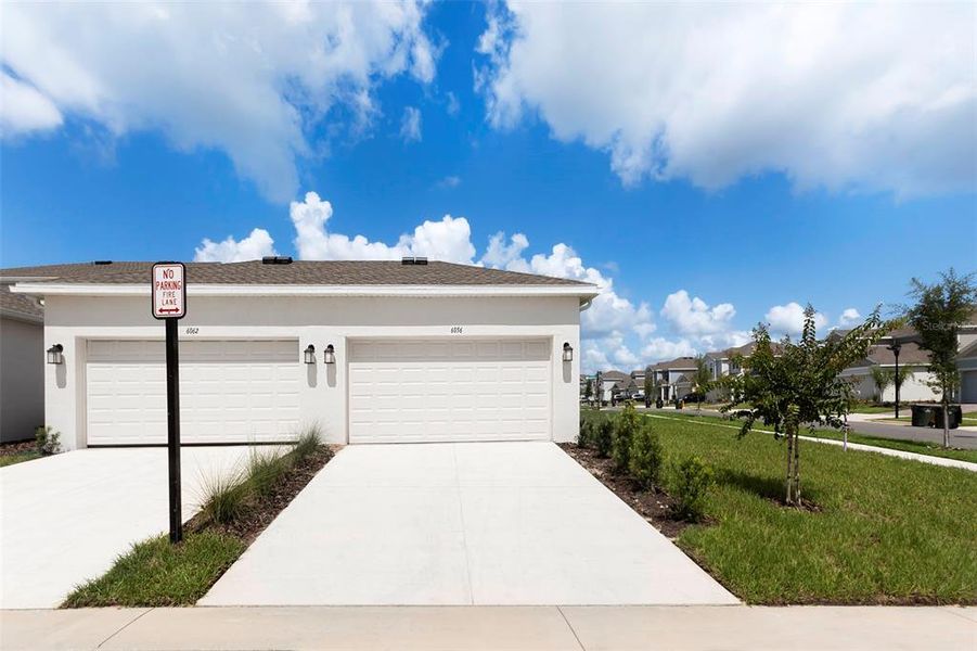 Front exterior of a new home in , Clermont, FL, highlighting curb appeal (Image 22).