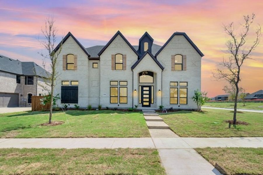 Front exterior of a new home in Malabar Hill, Prosper, TX, highlighting curb appeal (Image 1). Front exterior of a new home in Malabar Hill, Prosper, TX, highlighting curb appeal (Image 1).