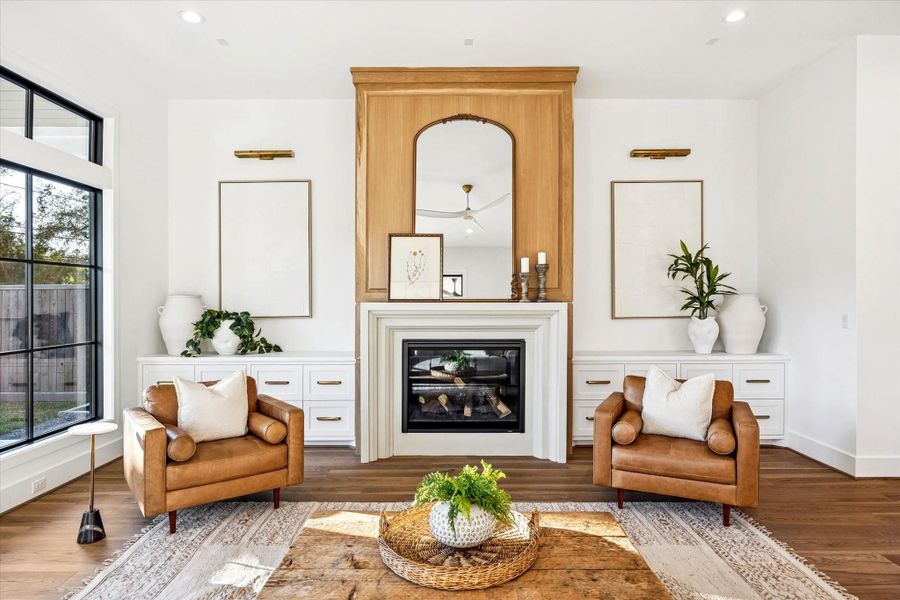 Custom millwork fireplace wall anchors the living room with integrated storage and balanced symmetry. Designed as a natural focal point, it adds warmth and architectural presence without overwhelming the surrounding space. **Previous build by Arch Angelo** Custom millwork fireplace wall anchors the living room with integrated storage and balanced symmetry. Designed as a natural focal point, it adds warmth and architectural presence without overwhelming the surrounding space. **Previous build by Arch Angelo**
