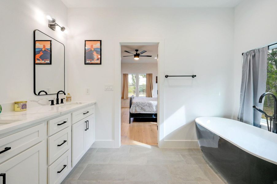 Ensuite bathroom with double vanity and a freestanding tub