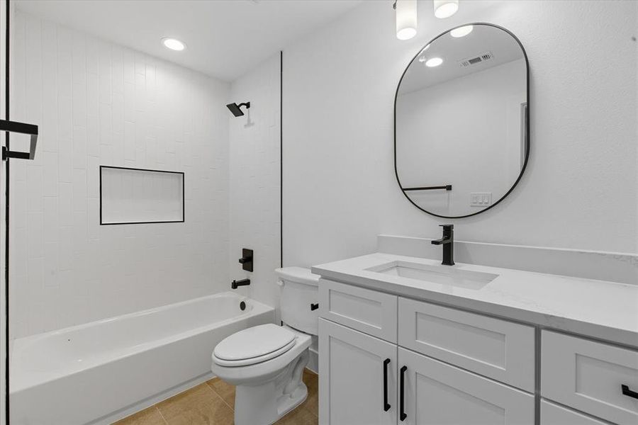 Full bathroom with  shower combination, vanity, light tile patterned floors, and recessed lighting