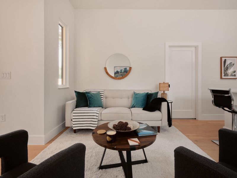 Living area with light wood finished floors and baseboards Living area with light wood finished floors and baseboards