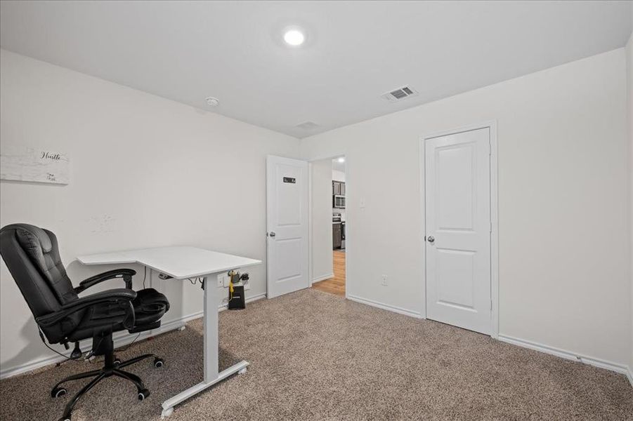 Home office with baseboards and light colored carpet Home office with baseboards and light colored carpet