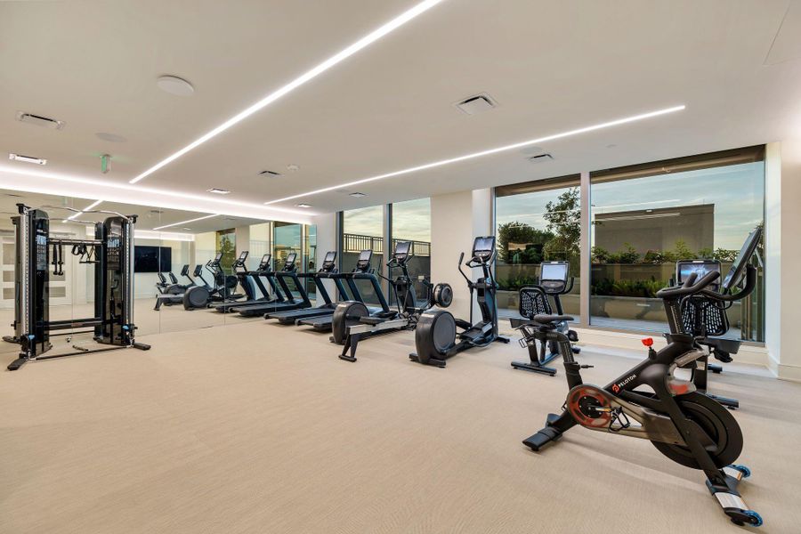 This photo shows a modern fitness center with large windows, natural light, and a variety of exercise equipment, including treadmills, stationary bikes, and weight machines. This photo shows a modern fitness center with large windows, natural light, and a variety of exercise equipment, including treadmills, stationary bikes, and weight machines.