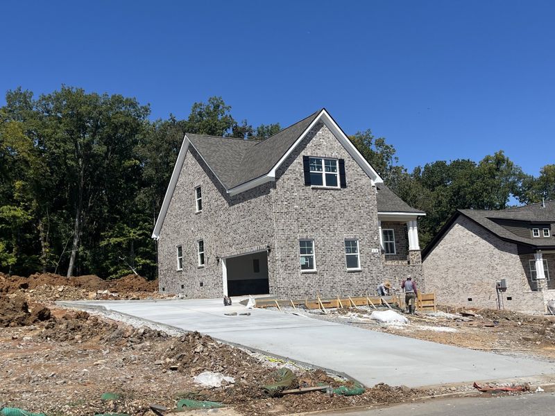 Side entry garage with extra concrete in driveway.