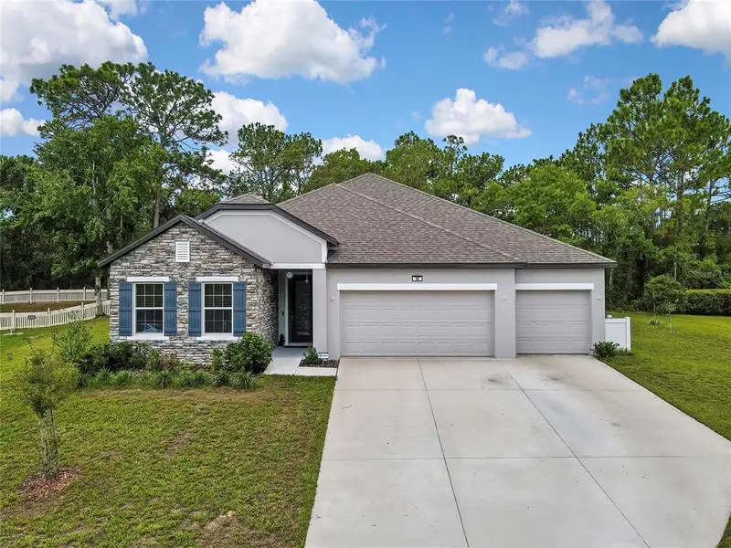 Front exterior of a new home in , Homosassa, FL, highlighting curb appeal (Image 22). Front exterior of a new home in , Homosassa, FL, highlighting curb appeal (Image 22).