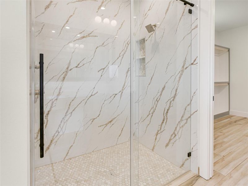 Oversize shower with 8-foot porcelain slab walls, customized shower glass doors.