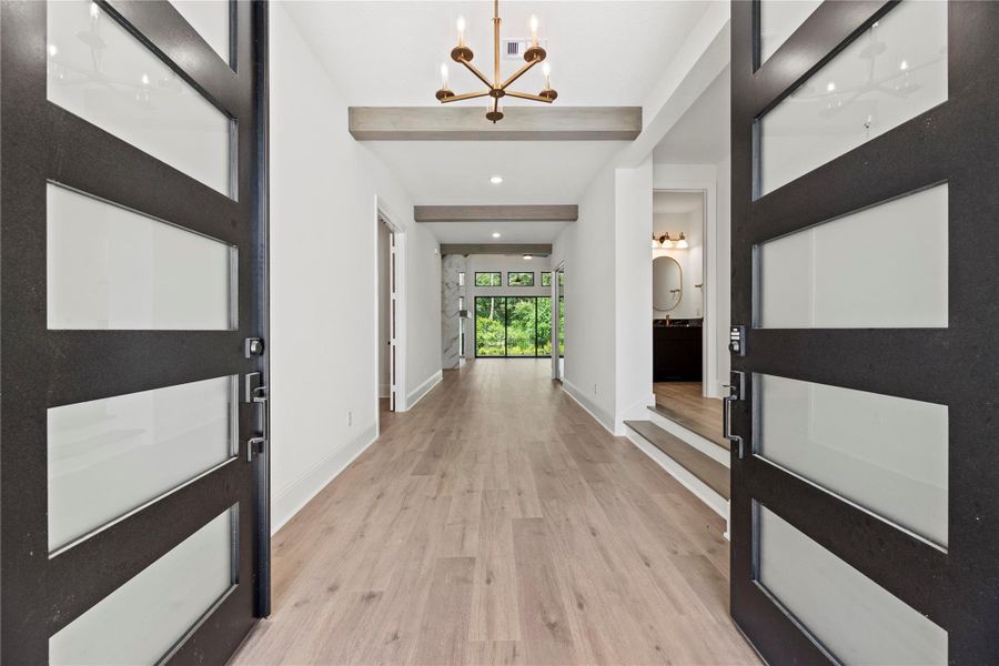 Gorgeous mahogany double front doors draw your eye to the breathtaking views.