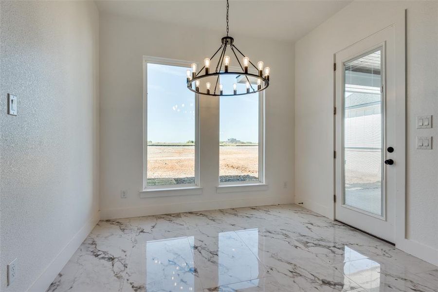 Unfurnished dining area featuring an inviting chandelier