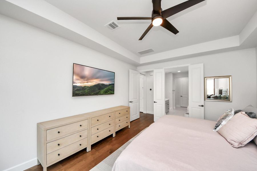 Primary bedroom with dual-entry bath access and walk-in closet.
