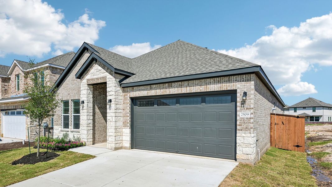 Front exterior of a new home in The Enclave at Bar W Ranch, Leander, TX, highlighting curb appeal (Image 2). Front exterior of a new home in The Enclave at Bar W Ranch, Leander, TX, highlighting curb appeal (Image 2).